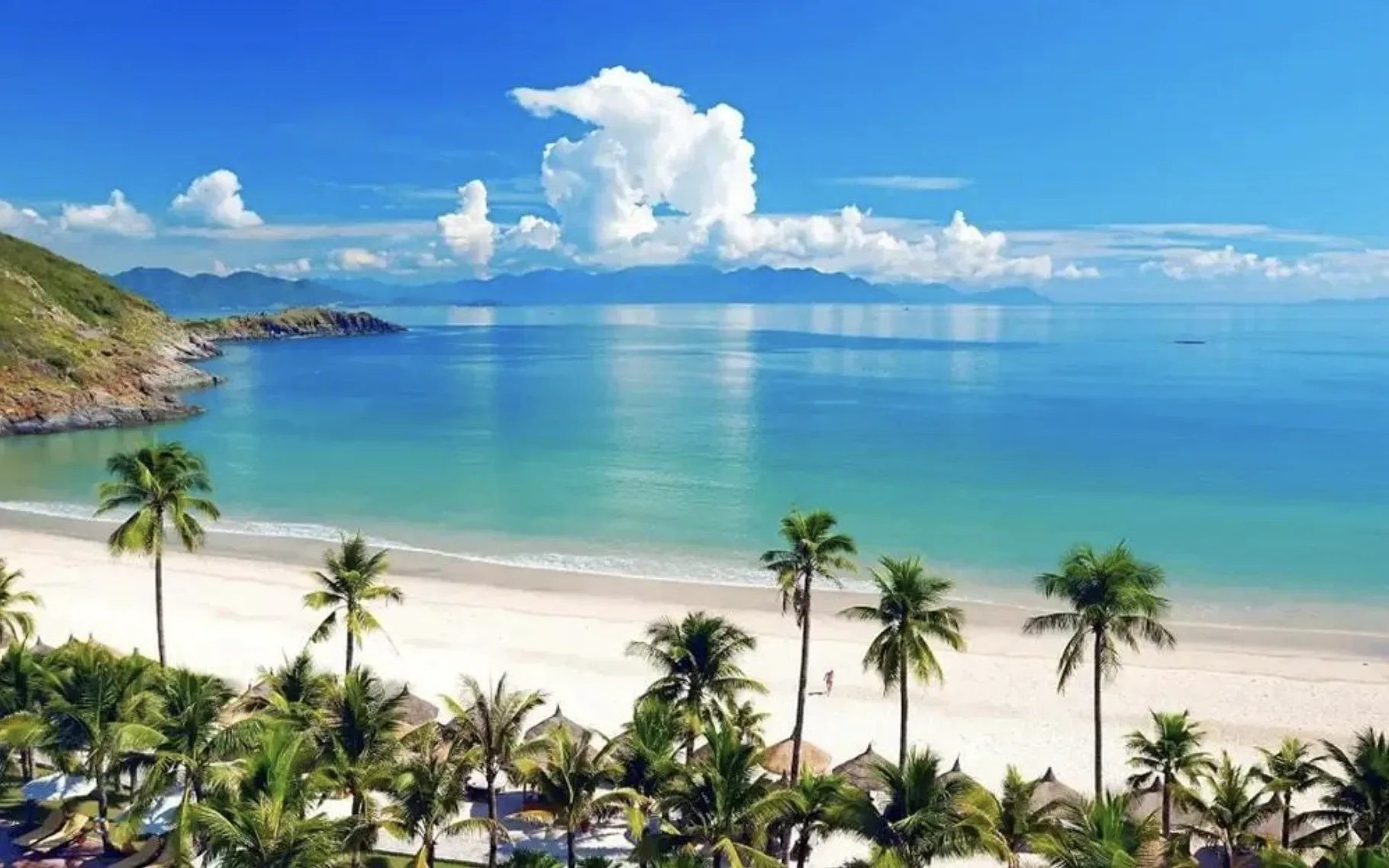 A bright Pacific beach and mountain coastline in Da Nang